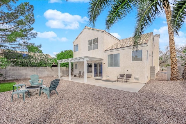 back of property featuring a patio, stucco siding, fence, a pergola, and a fire pit