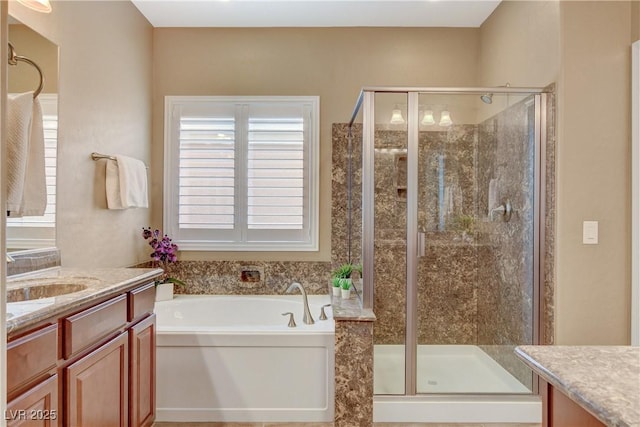 full bathroom with a wealth of natural light, a stall shower, and vanity