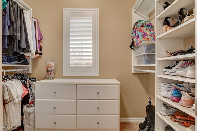 walk in closet with tile patterned floors