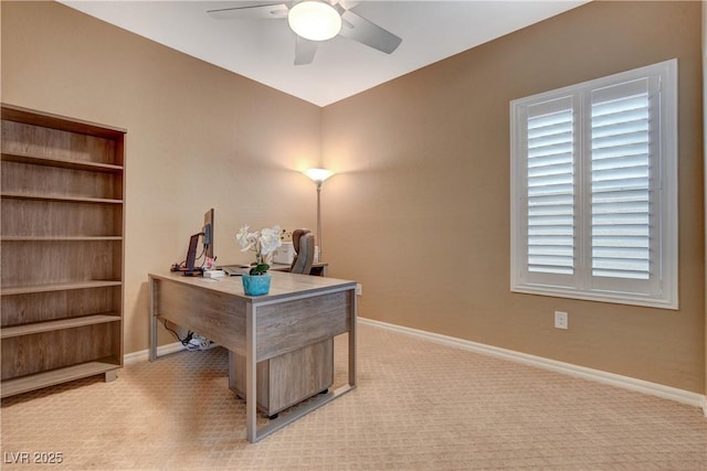 office area with light colored carpet, baseboards, and ceiling fan