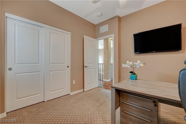 office area with visible vents, baseboards, and ceiling fan