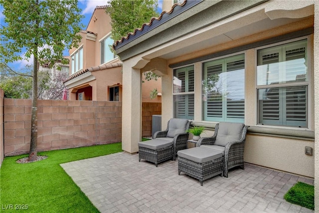 view of patio / terrace with an outdoor living space and fence