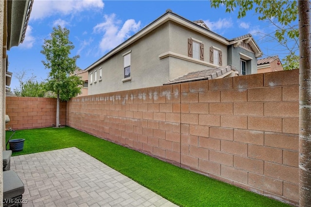 view of yard featuring a patio area and a fenced backyard