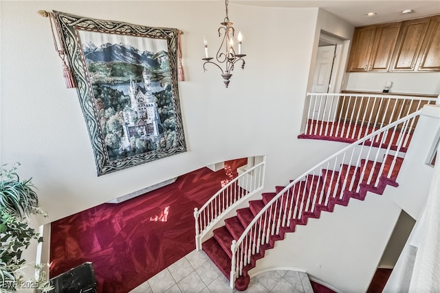 stairway with an inviting chandelier and tile patterned flooring