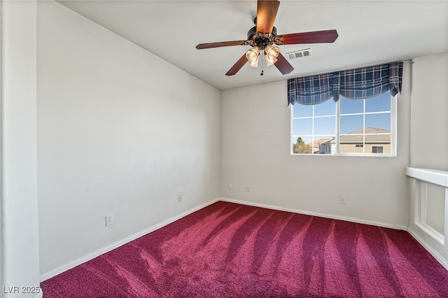 unfurnished room with carpet flooring, a ceiling fan, visible vents, and baseboards