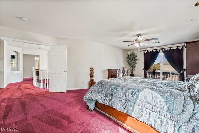 carpeted bedroom with visible vents, baseboards, and ceiling fan