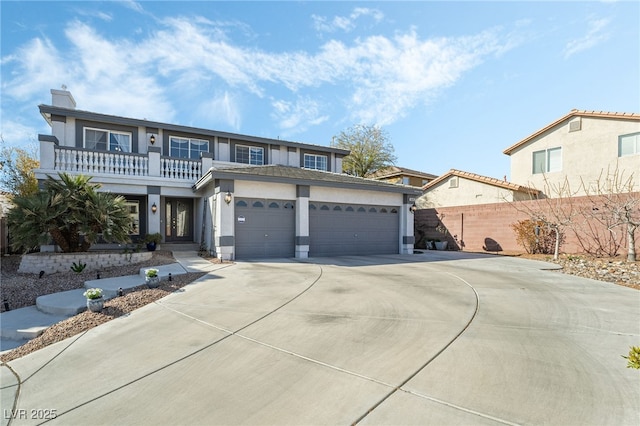 view of front of property with fence, stucco siding, driveway, a balcony, and an attached garage