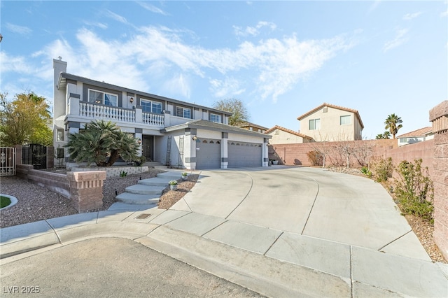 view of front of home with a chimney, concrete driveway, a balcony, and fence