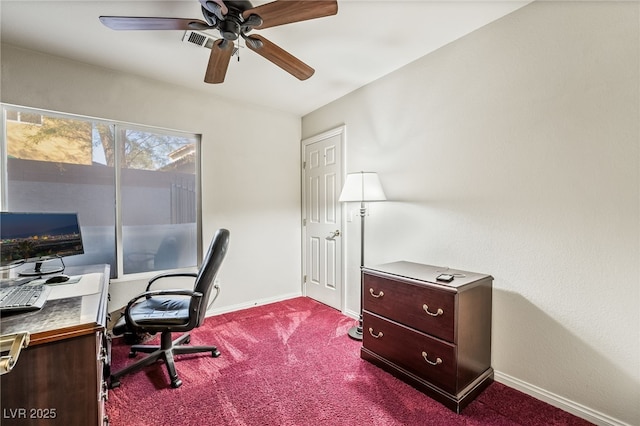 office space with visible vents, dark carpet, baseboards, and ceiling fan