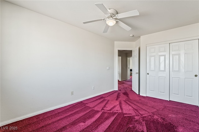 unfurnished bedroom featuring a ceiling fan, baseboards, dark colored carpet, and a closet