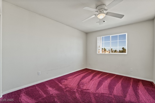 carpeted spare room featuring visible vents, baseboards, and ceiling fan