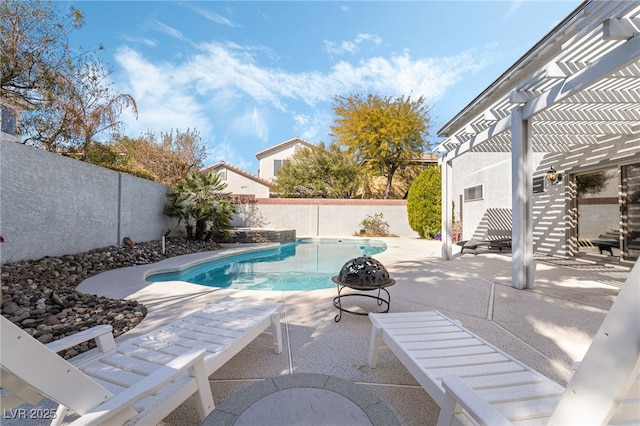 view of swimming pool with a patio, a fenced in pool, a fenced backyard, and a pergola