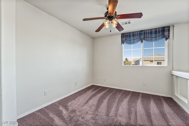 carpeted spare room with baseboards, visible vents, and ceiling fan