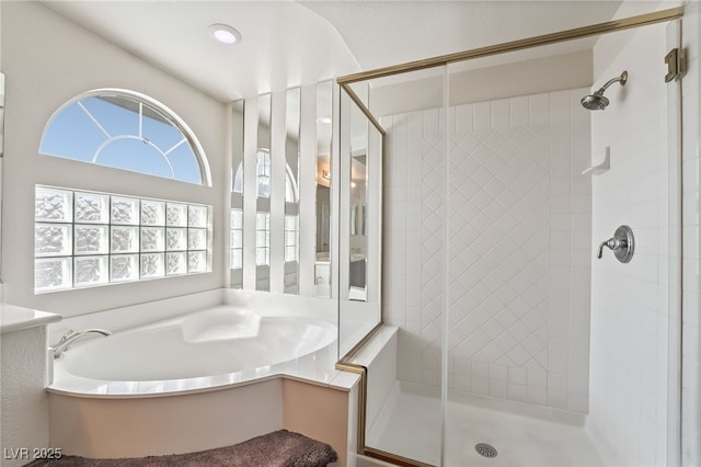 bathroom featuring a bath and a stall shower