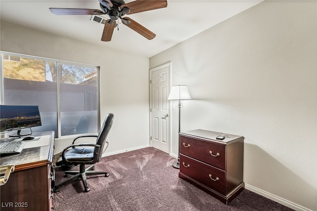 home office with dark carpet, visible vents, a ceiling fan, and baseboards