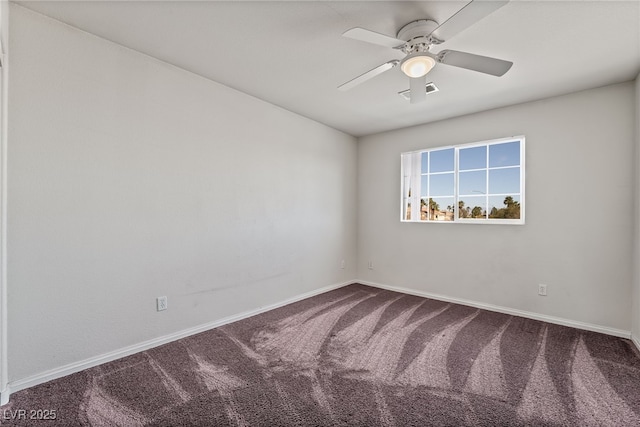 carpeted spare room with visible vents, a ceiling fan, and baseboards