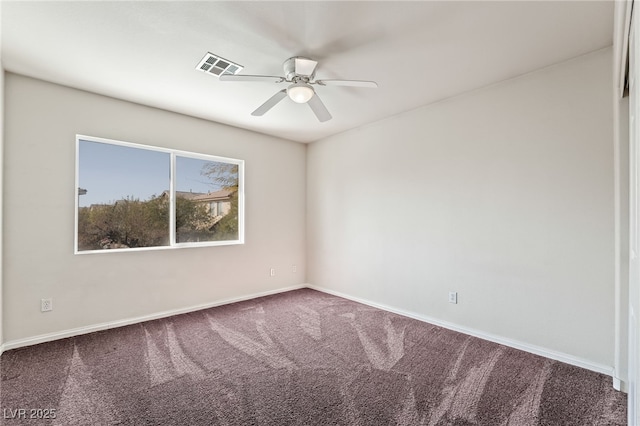 carpeted spare room featuring baseboards, a ceiling fan, and visible vents