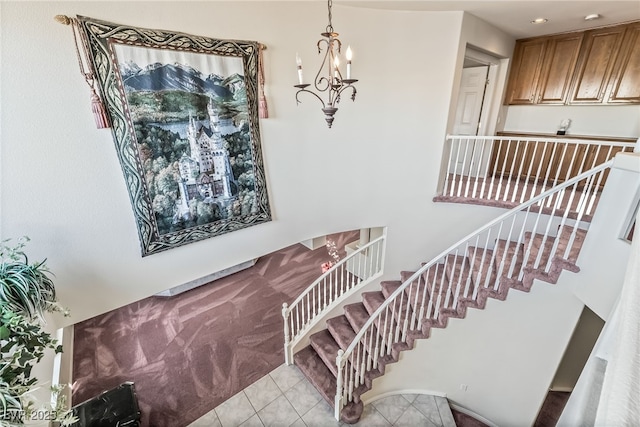 staircase with a chandelier