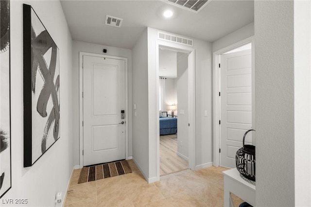 entrance foyer featuring visible vents, baseboards, and light tile patterned flooring