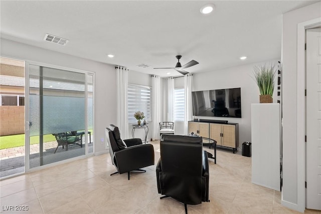 living area with light tile patterned floors, visible vents, recessed lighting, and ceiling fan