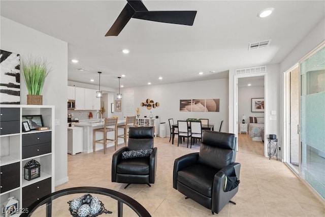 living room featuring recessed lighting, visible vents, light tile patterned flooring, and a ceiling fan