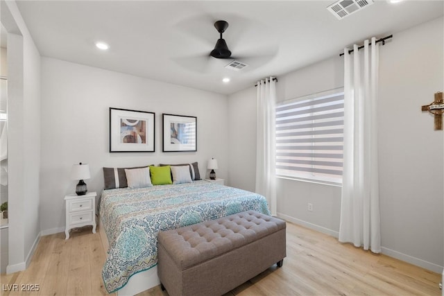 bedroom featuring visible vents, baseboards, and light wood-style floors