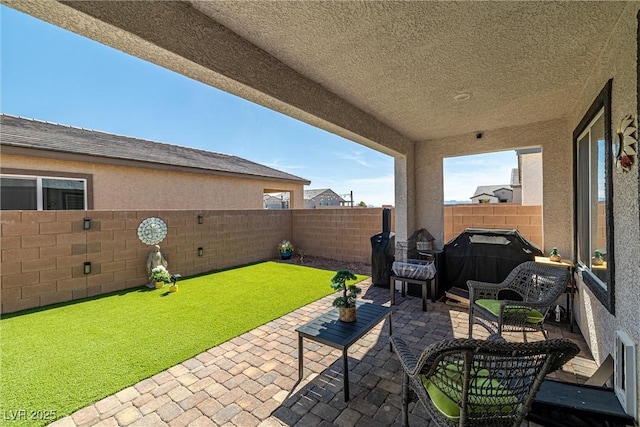 view of patio / terrace featuring area for grilling and a fenced backyard