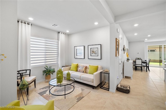 living room featuring light tile patterned floors, visible vents, recessed lighting, and baseboards