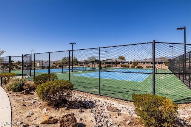 view of sport court featuring fence