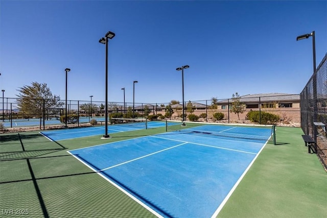 view of tennis court featuring fence