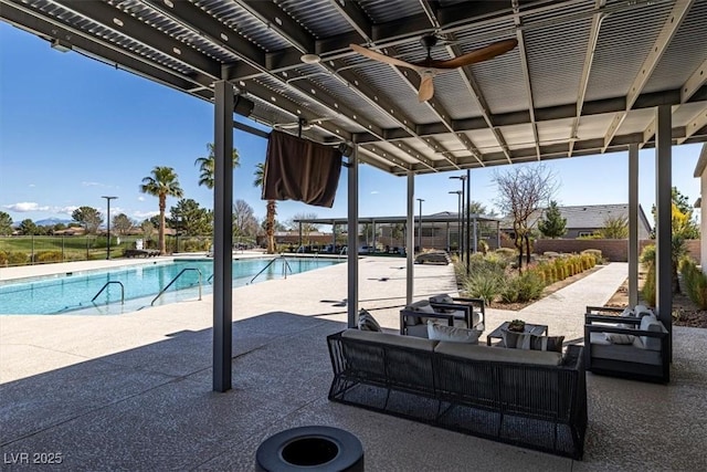 view of patio featuring an outdoor living space, a grill, and a community pool