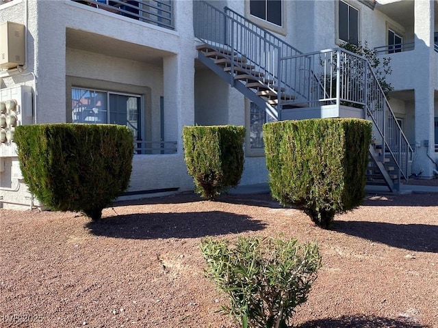 entrance to property featuring stucco siding