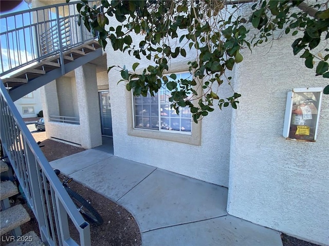 view of exterior entry featuring stucco siding