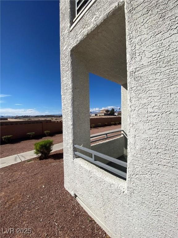 exterior details with fence and stucco siding