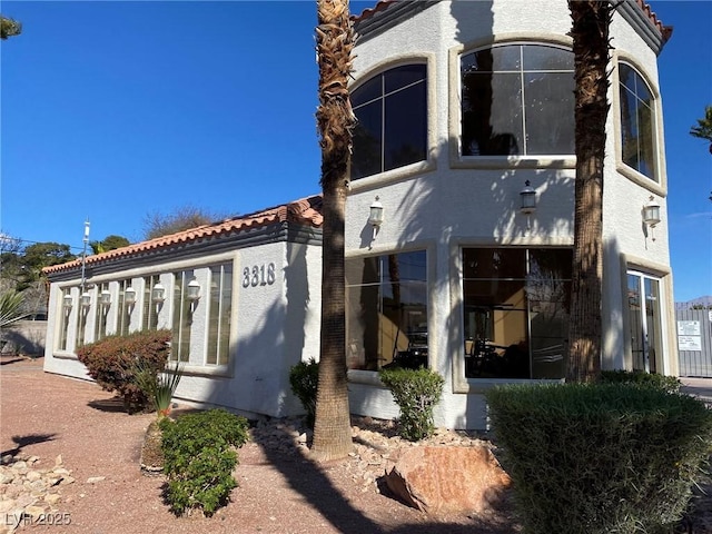 view of front of house featuring a tile roof and stucco siding