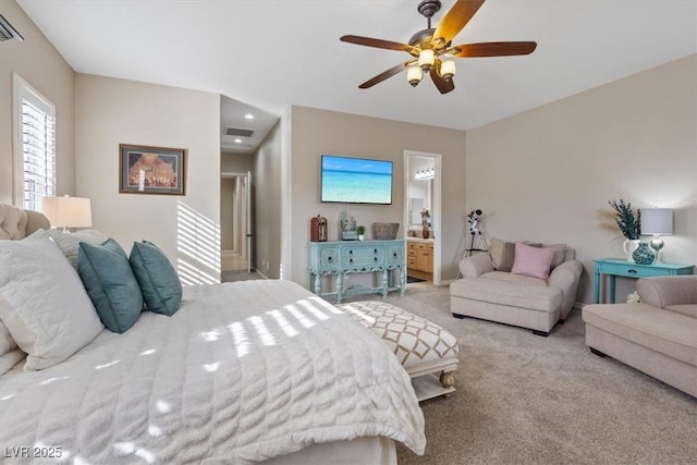 carpeted bedroom featuring ceiling fan, visible vents, and connected bathroom