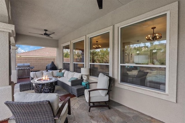 view of patio with a grill, an outdoor living space with a fire pit, a ceiling fan, and fence