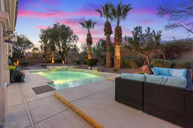 pool at dusk featuring a fenced in pool, a fenced backyard, a patio, and an outdoor hangout area