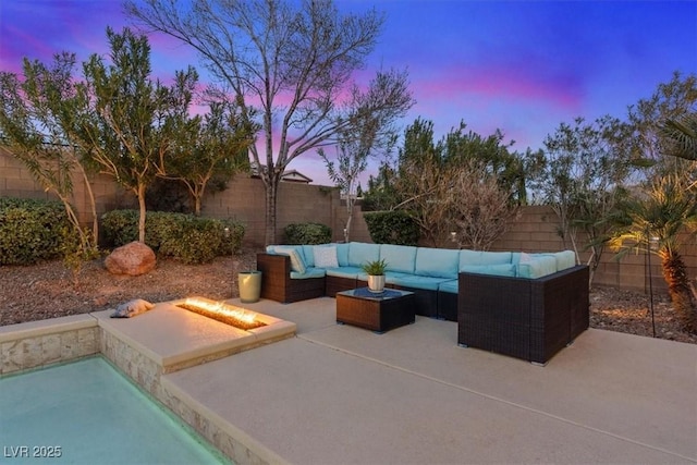 view of patio / terrace featuring a fenced backyard and an outdoor living space with a fire pit