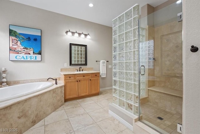 bathroom featuring a garden tub, a shower stall, tile patterned floors, and vanity