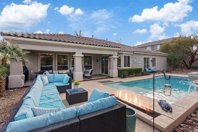 back of property with an outdoor pool, a patio, an outdoor hangout area, a tiled roof, and stucco siding