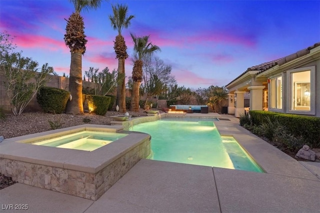 pool at dusk featuring an in ground hot tub, a patio, a fenced backyard, and a fenced in pool