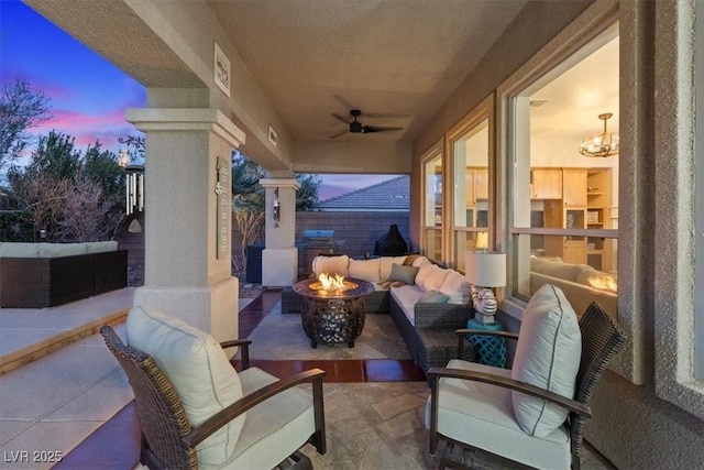 view of patio with an outdoor living space with a fire pit, ceiling fan, and fence