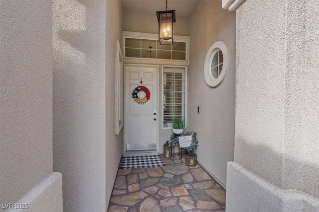 doorway to property with stucco siding