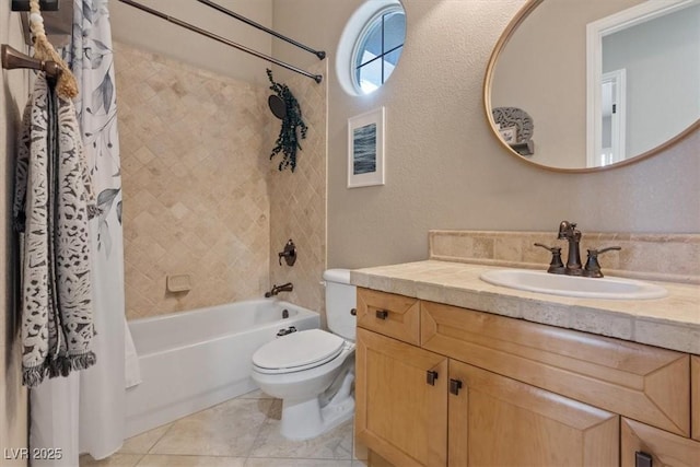 full bath featuring a textured wall, shower / tub combo, vanity, and toilet