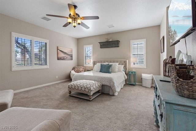 bedroom with light carpet, a ceiling fan, visible vents, and baseboards