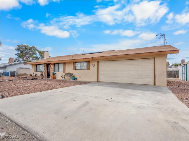 ranch-style house with solar panels, fence, and stucco siding