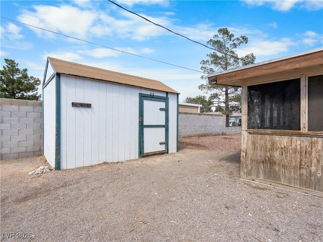 view of shed with fence