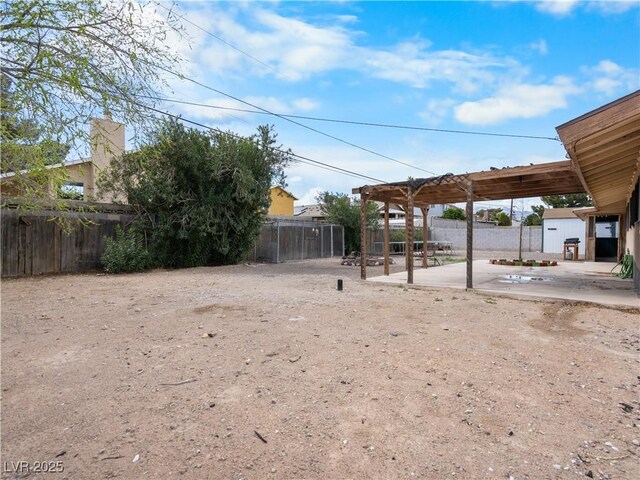 view of yard featuring a patio area, a pergola, and a fenced backyard