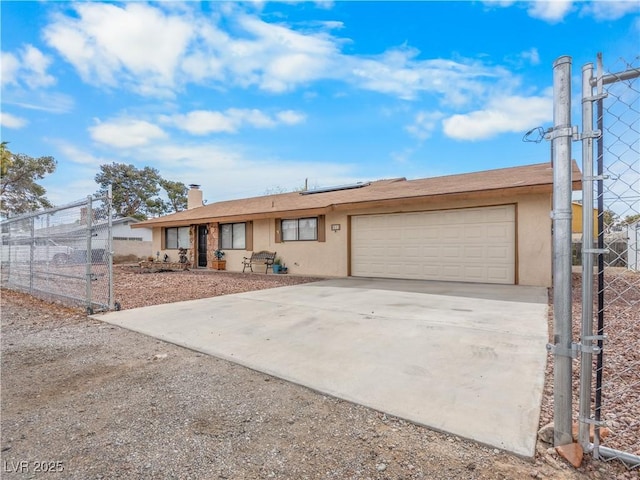 ranch-style house with fence, solar panels, stucco siding, concrete driveway, and a garage